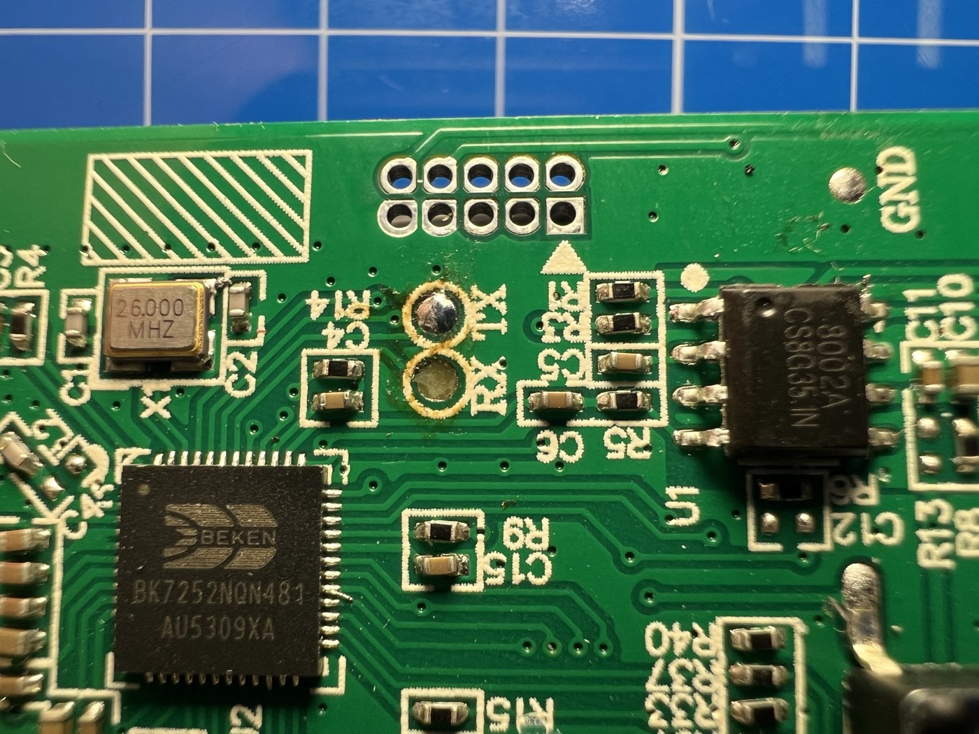 Close-up of the BK7252N MCU with UART pads, unpopulated JTAG header, and audio amp